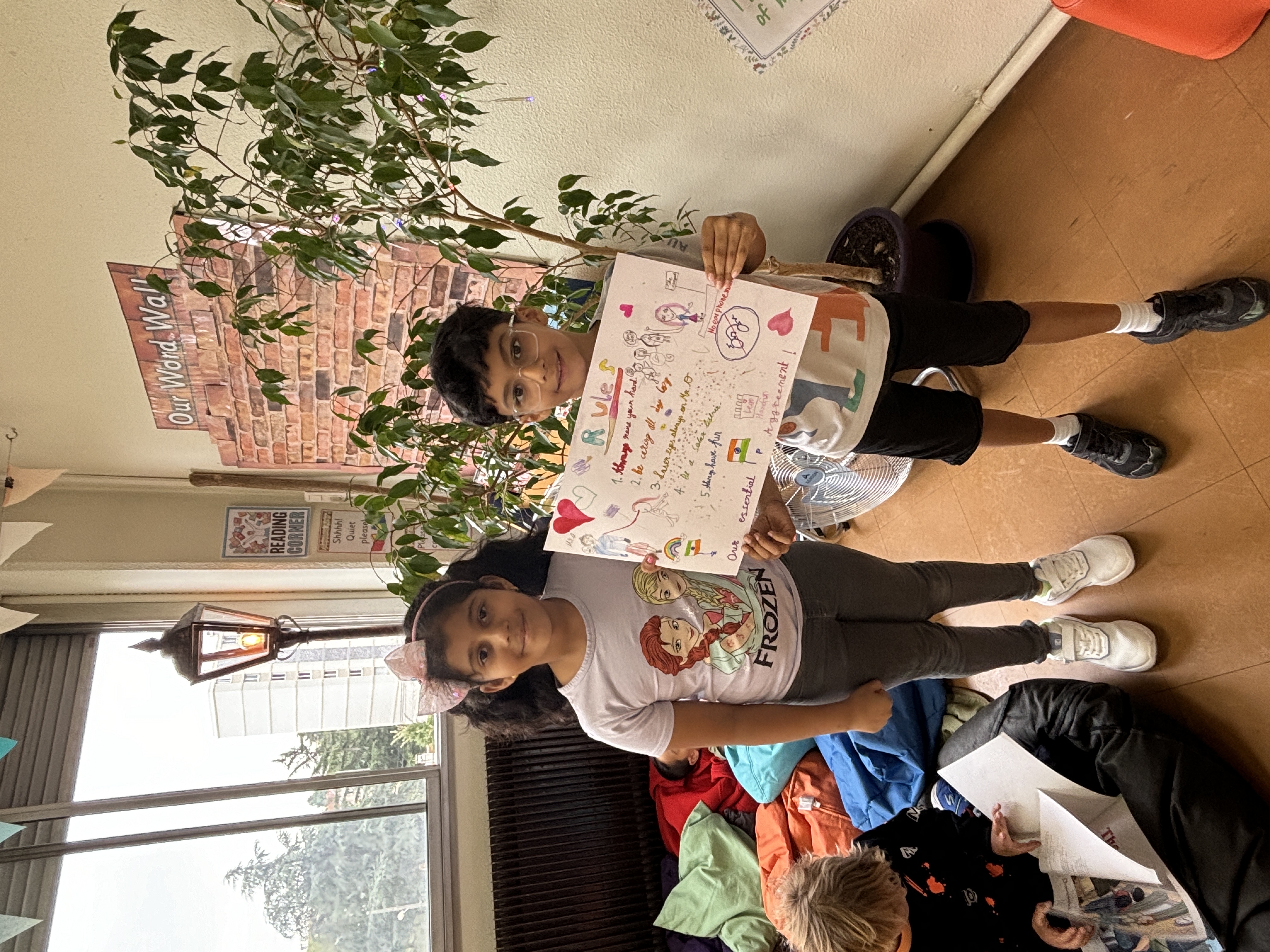 2 students holding up a sign with their class rules