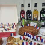 Pastries and juice arranged on a table with French flags as decoration